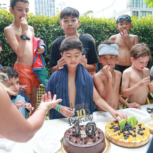 Kids enjoying a poolside birthday party at TRIBE Living Bangkok Sukhumvit 39 with party packages and balloon decorations.